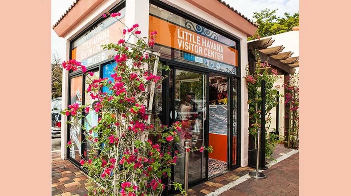 Exterior etrance of the Little Havana Visitor Center with a climbing rose bush on the exterior walls