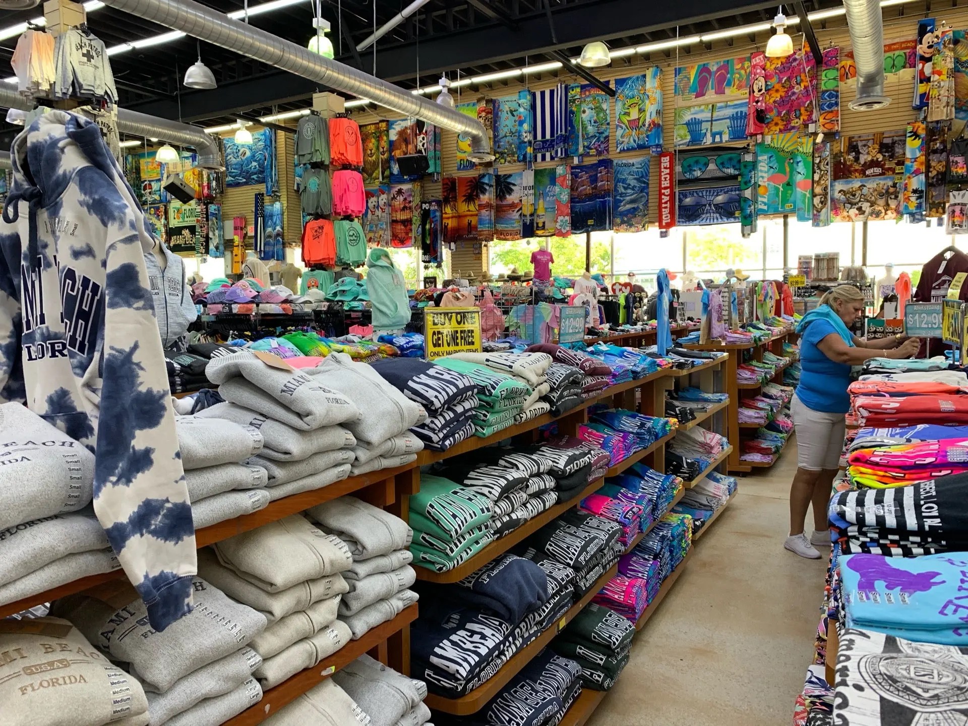 Interior of Wing's Beachwear gift shop cluttered with shelves of stacked clothing and misc. beachwear